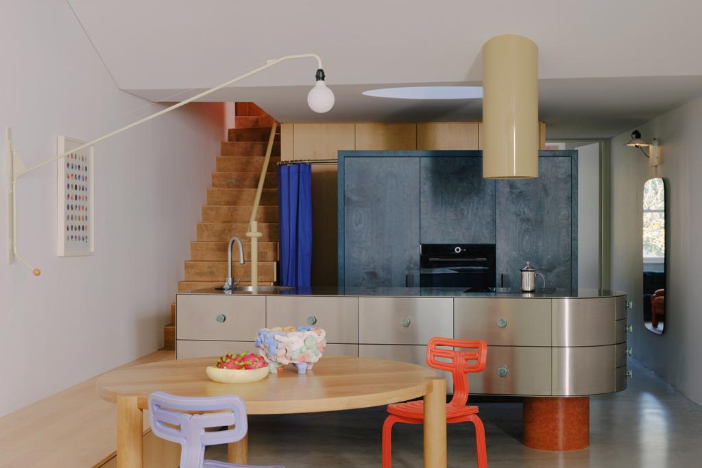 Elan stainless steel cabinetry featuring Handle & Kate Malabar cabinet handle in Lagoon, a sheer blue/green gloss glaze